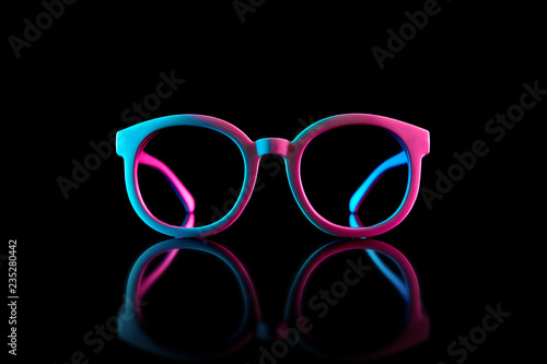 Stylish sunglasses shot using pink and blue abstract colored lighting with copy space.