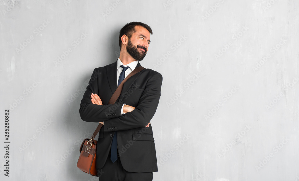 Businessman with beard looking over the shoulder with a smile Businessman with beard looking over the shoulder with a smile