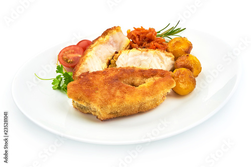 Golden Fried Fish Fillet with herbs, pepper and tomatoes, isolated on a white background. Close-up