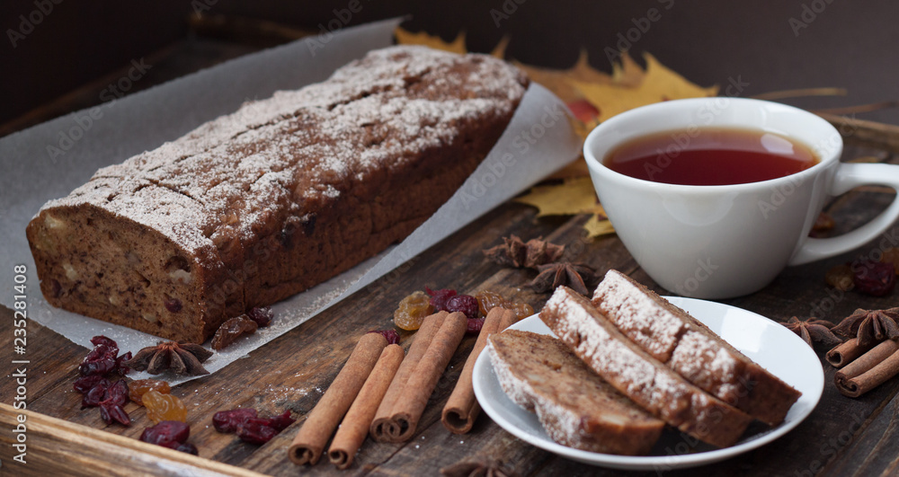 Homemade banana bread with anis star and cinnamon on a dark wooden background Homemade banana bread with anis star and cinnamon on a dark wooden background