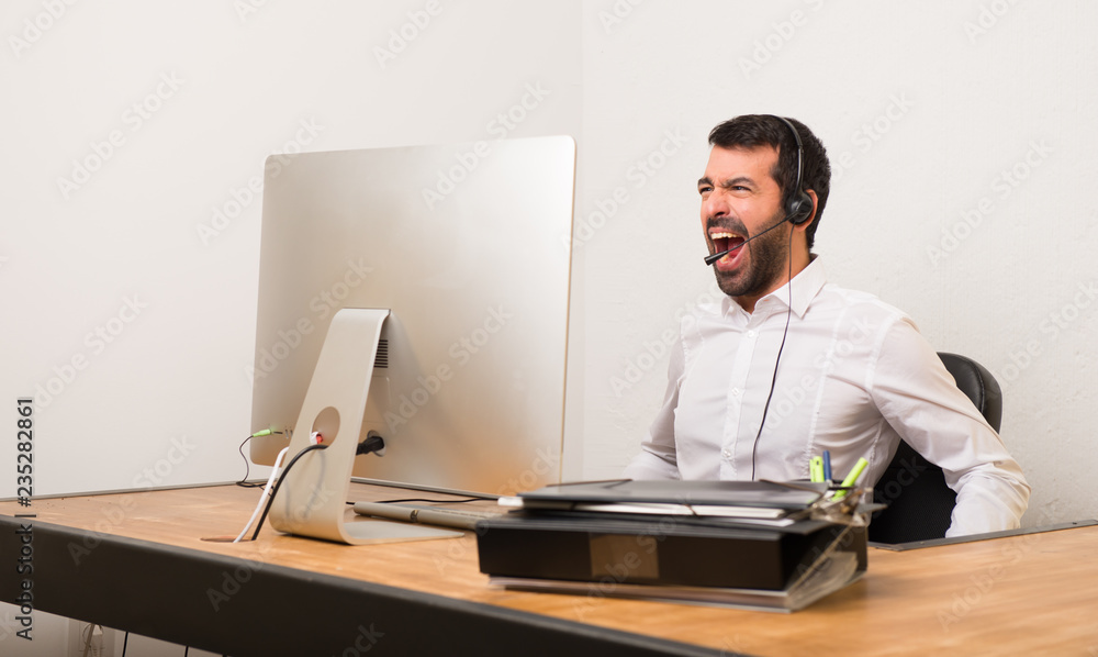 Telemarketer man in a office shouting to the front with mouth wide open Telemarketer man in a office shouting to the front with mouth wide open