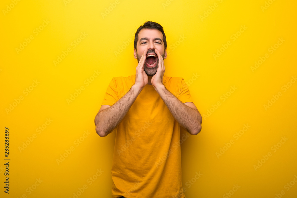 Man on isolated vibrant yellow color shouting and announcing something Man on isolated vibrant yellow color shouting and announcing something