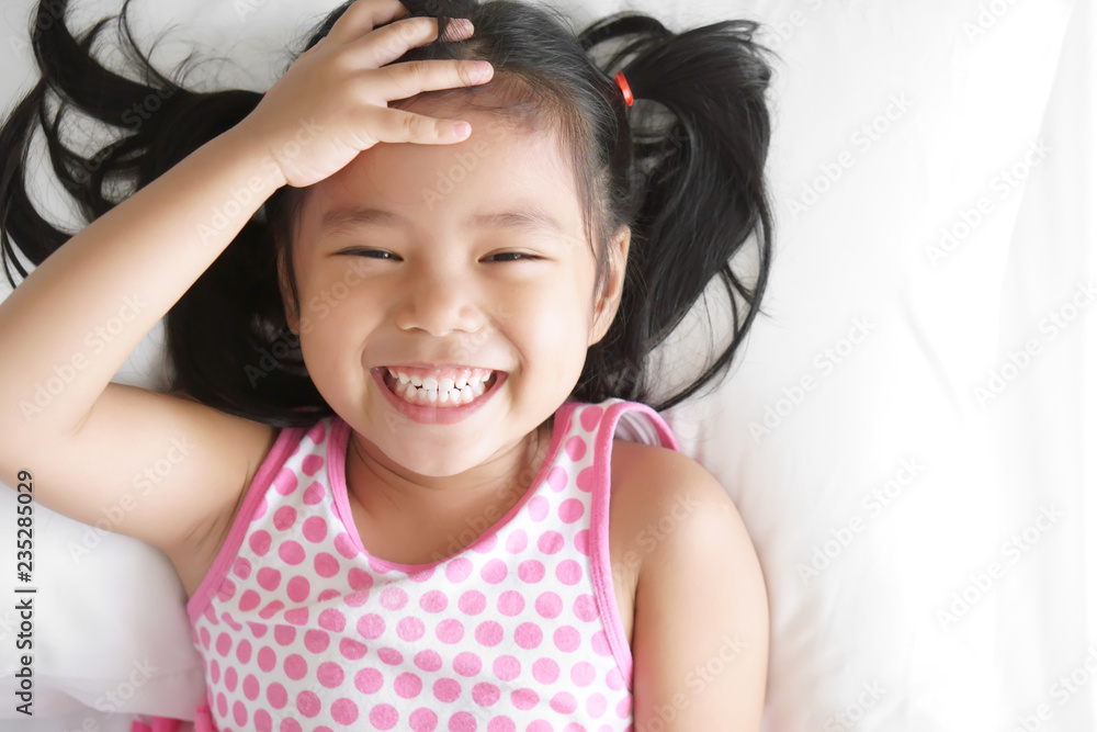 Asian child happy or kid girl smiling and open eye sleep or wake up for  relax