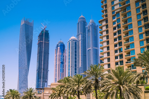 Dubai skyline with skyscrapers on a sunny day. Construction concept.