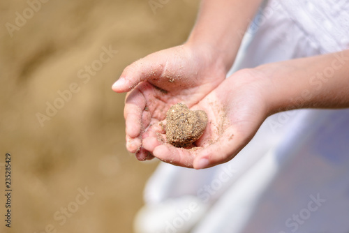 little girl holding sea sand