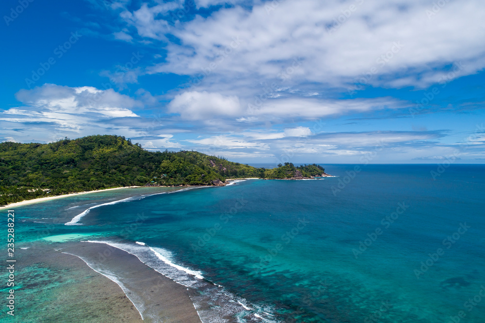 Tropical beach with sea and palm taken from drone. Beach and sea photo. Romantic beach aerial view.