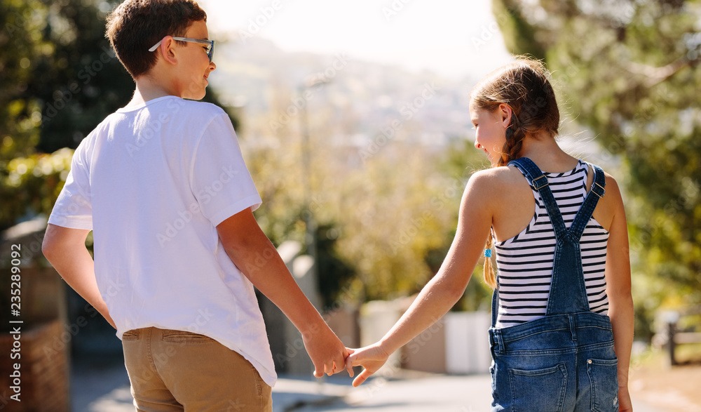 Happy kids in love standing on street and talking Happy kids in love standing on street and talking