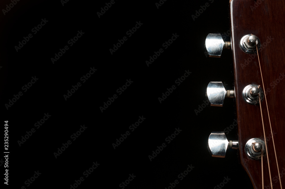 Acoustic guitar headstock on black backround Acoustic guitar headstock on black backround