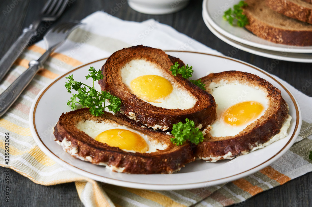 Baked toasts with egg filling and fresh parsley on a plate    