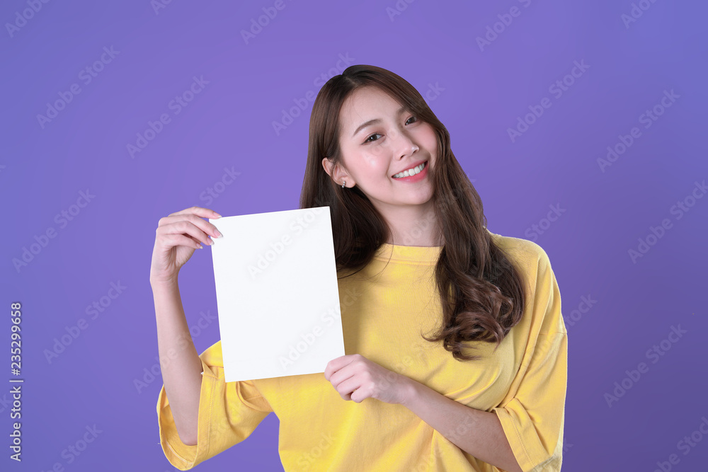 Young student woman show a blank resume, yellow t-shirt clothing, purple background Young student woman show a blank resume, yellow t-shirt clothing, purple background