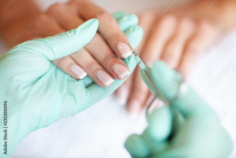 Woman Hand Care. Closeup Of Beautiful Female Hands Having Spa Manicure At Beauty Salon. Beautician Filing Clients Healthy Natural Nails With Nail File. Nail Treatment Woman Hand Care. Closeup Of Beautiful Female Hands Having Spa Manicure At Beauty Salon. Beautician Filing Clients Healthy Natural Nails With Nail File. Nail Treatment