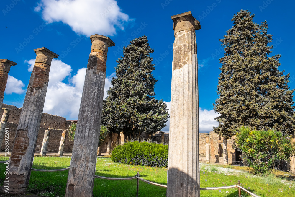 Ancient columns on the garden on Villa in Pompeii, destroyed city.