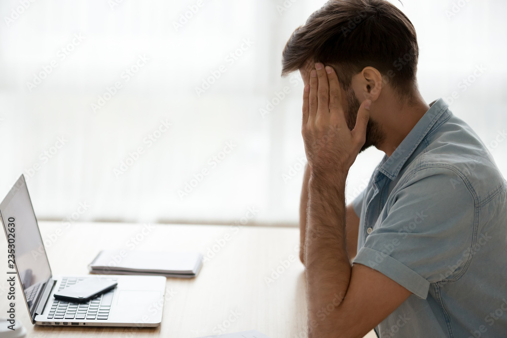 Tired male sitting at office desk massaging temples suffer from headache or blood pressure, exhausted man feel unwell having spasm or blurry vision, guy taking break from work. Health problems concept Tired male sitting at office desk massaging temples suffer from headache or blood pressure, exhausted man feel unwell having spasm or blurry vision, guy taking break from work. Health problems concept