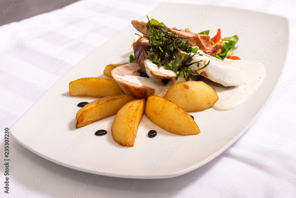 Royal file and potatoes sprinkled with white sauce with dried plums Royal file and potatoes sprinkled with white sauce with dried plums