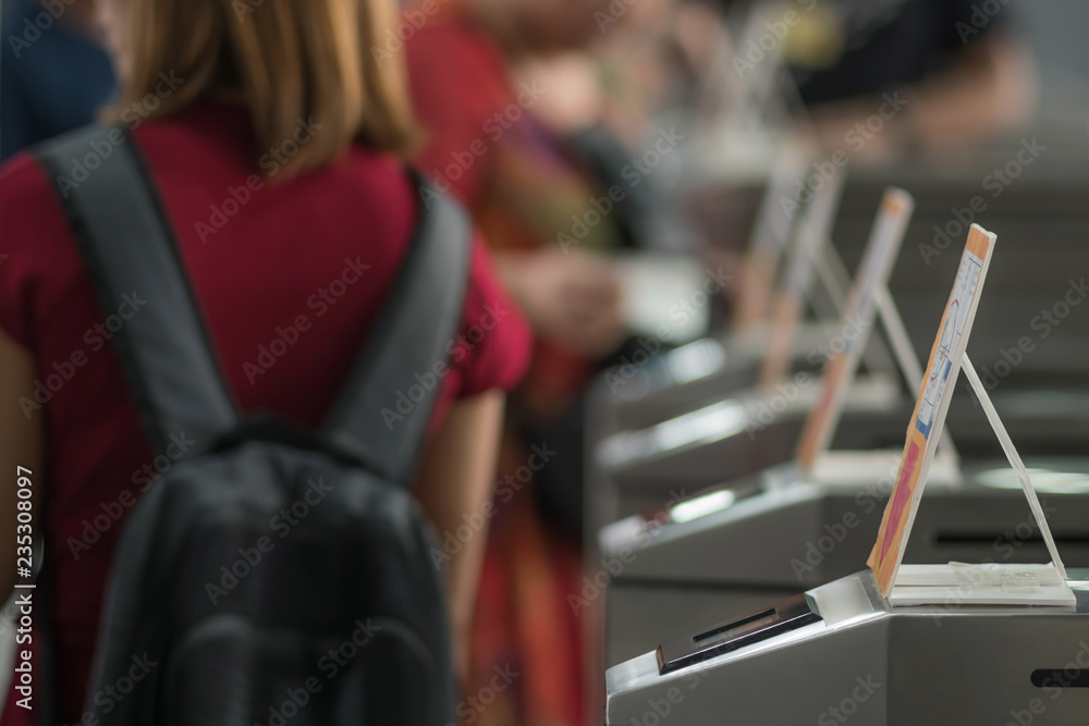 Many Tourists at pedestrian access control flap barriers. Select Many Tourists at pedestrian access control flap barriers. Select