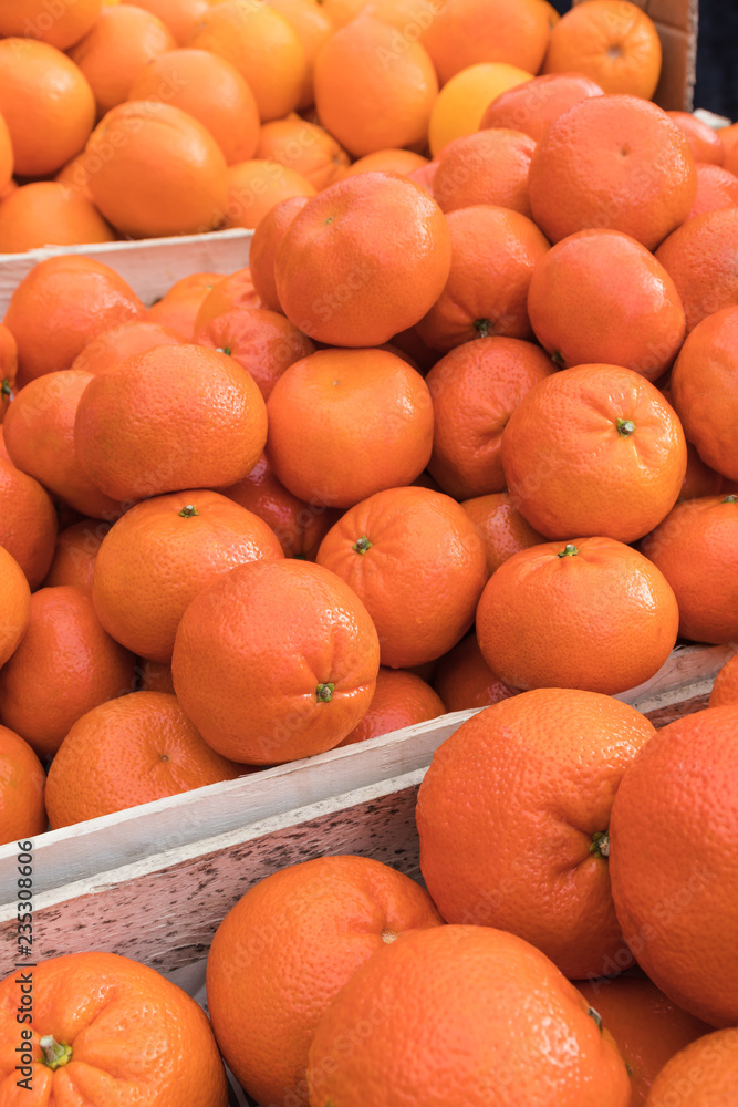 Fresh mandarin fruit, tangerines and oranges in the market as background