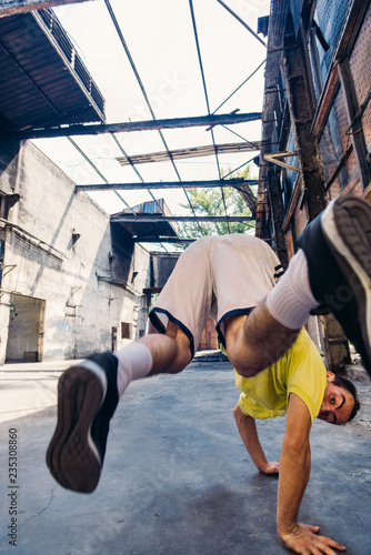 Parkour man exercise handstand outdoors