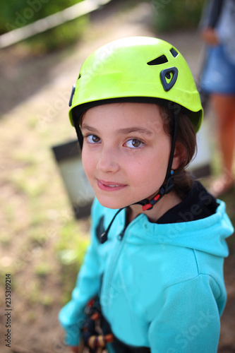 girl in a helmet on a rope park