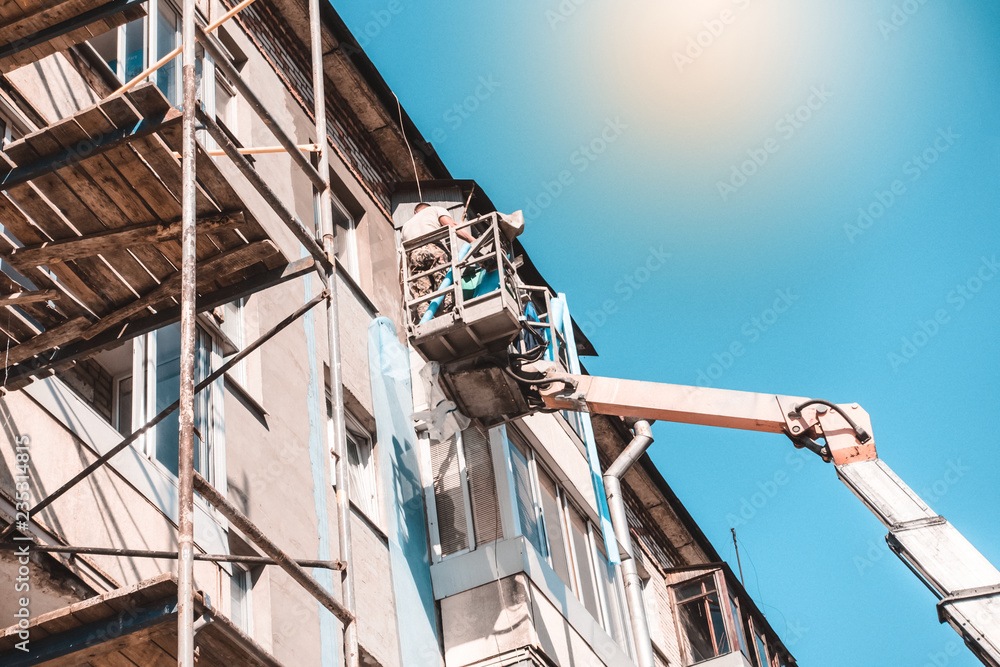 workers repair the building on high crane. workers repair the building on high crane.