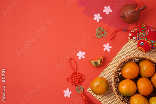 Chinese New Year background with traditional decorations for Spring festival on red table.