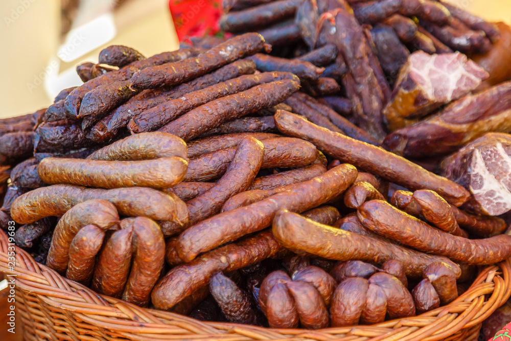 Fototapeta premium Smoked sausages and meat for sale on a shop.