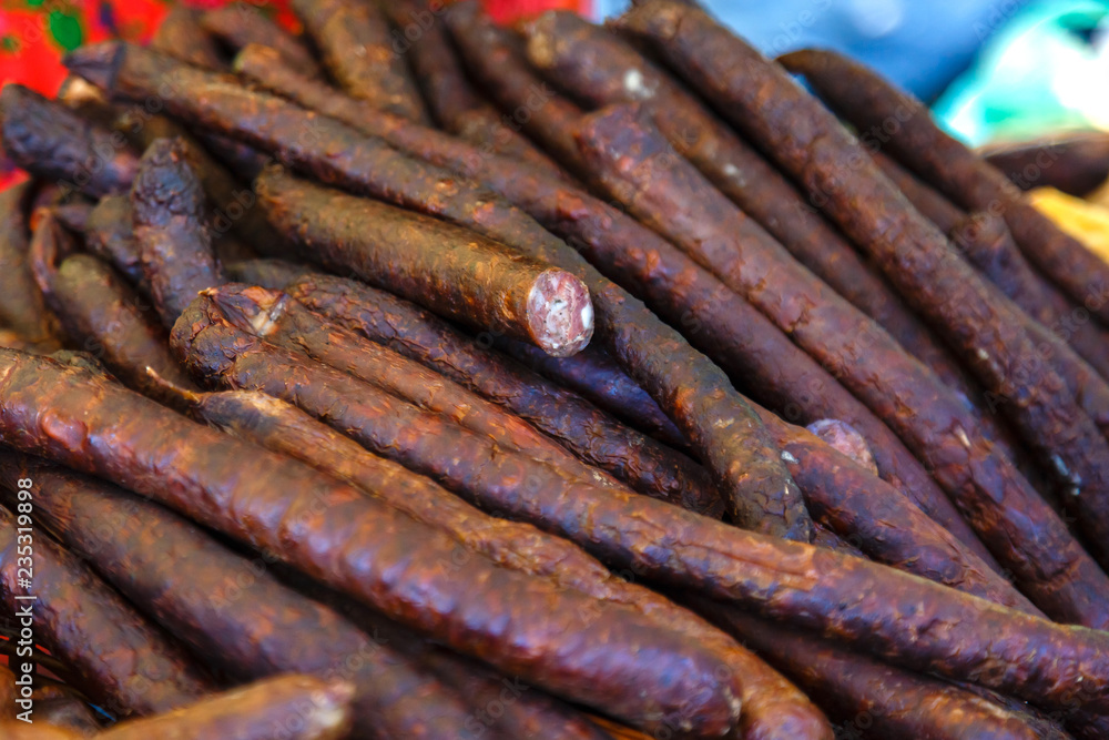 Smoked sausages for sale on a market. Smoked sausages for sale on a market.