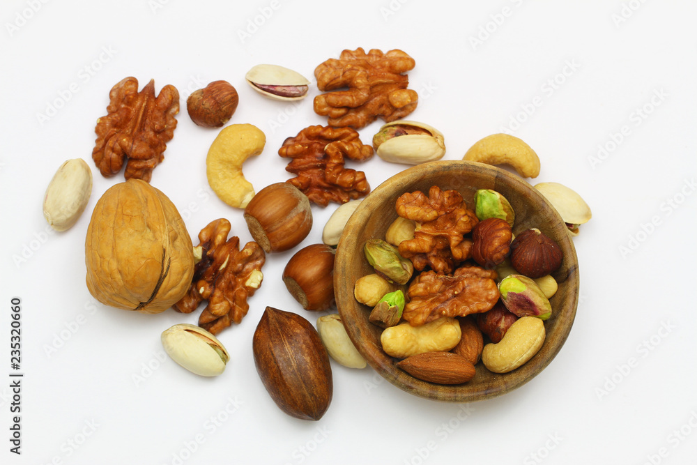 Selection of walnuts, hazelnuts, cashew nuts and almonds in miniature bamboo bowl on white surface with copy space
Selection of walnuts, hazelnuts, cashew nuts and almonds in miniature bamboo bowl on white surface with copy space