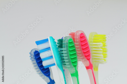 Closeup of few colorful toothbrushes on white background 