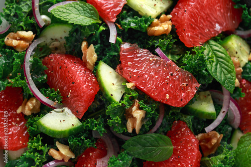 Healthy vegan  vegetarian Grapefruit kale salad with walnuts  red onion and cucumber