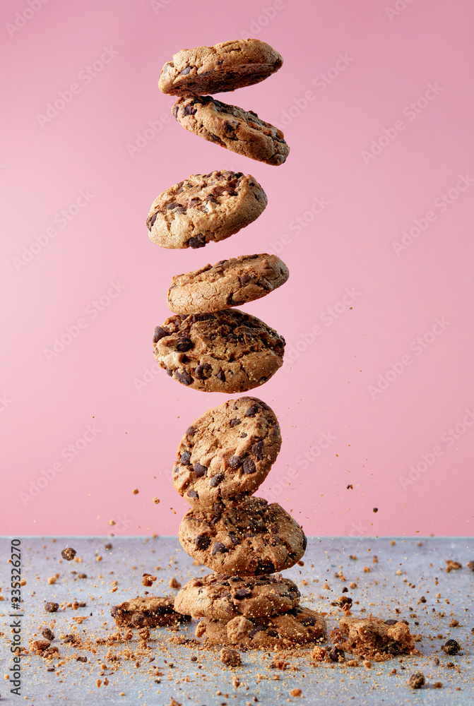 Chocolate chip cookies falling in stack - obrazy, fototapety, plakaty 
