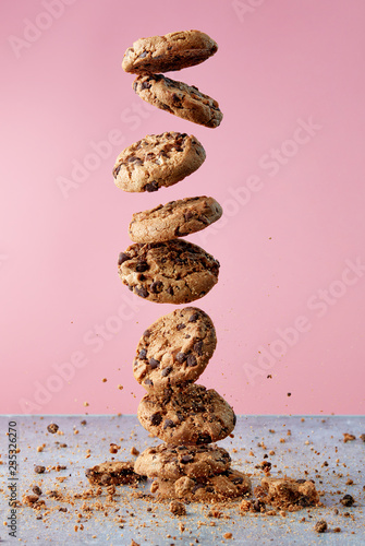Chocolate chip cookies falling in stack photo