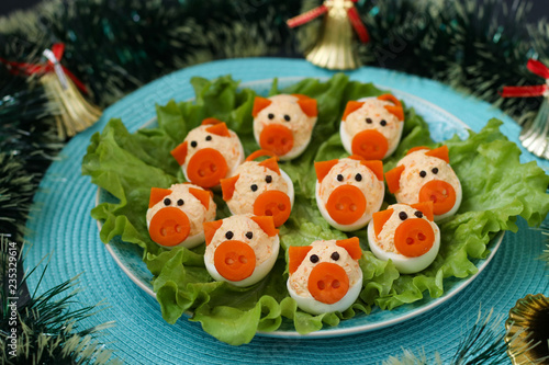 Stuffed eggs "Pigs" for 2019. Christmas idea for children. Symbolic food for new year 2019