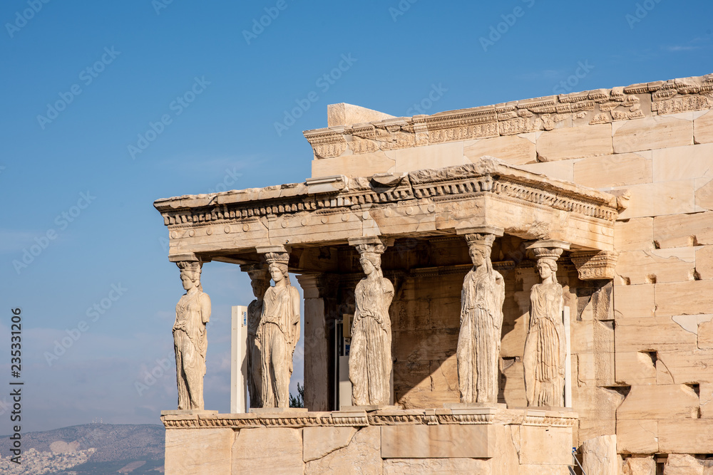 The ancient Erechtheion temple with the beautiful Caryatid pillars on the porch, on the Acropolis in Athens, Greece. The ancient Erechtheion temple with the beautiful Caryatid pillars on the porch, on the Acropolis in Athens, Greece.