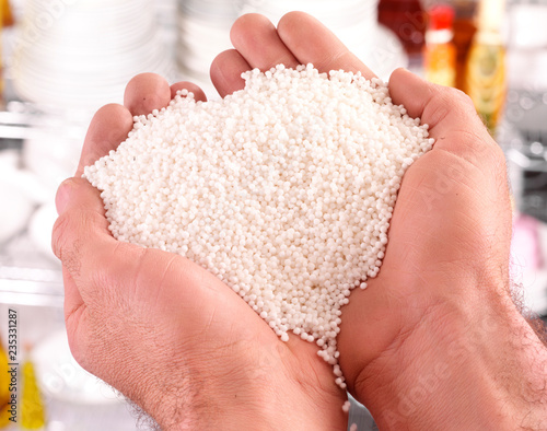 MAN 'S HANDS WITH HANDFUL OF SAGO PEARLS