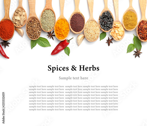Composition with different aromatic spices in wooden spoons on white background