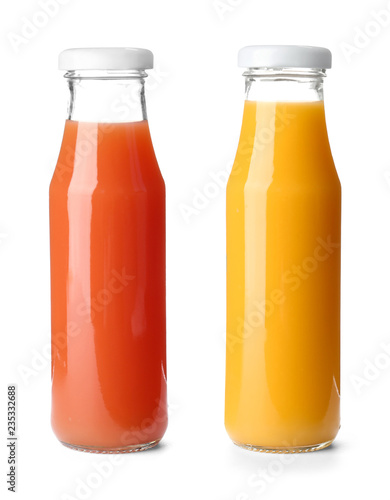 Set with glass bottles of different juices on white background