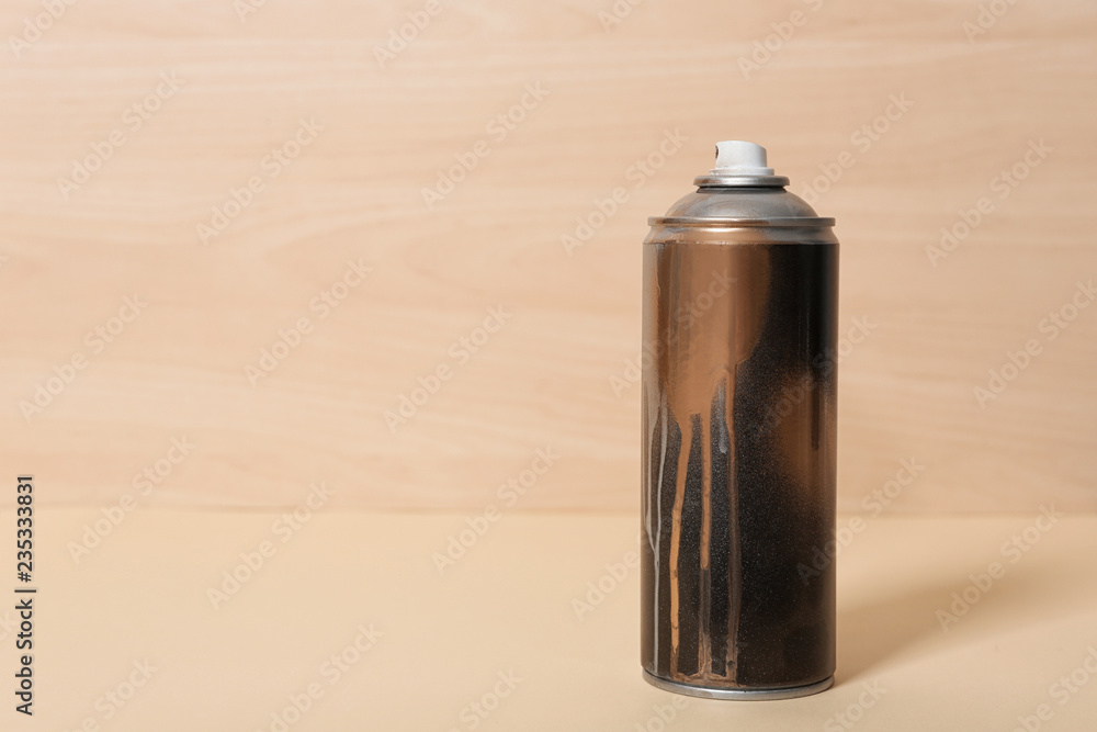 Used can of spray paint on wooden background. Space for text Used can of spray paint on wooden background. Space for text