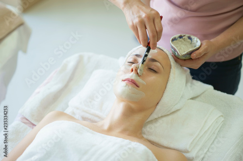 Beautiful caucasian woman having mask  lying on spa. Facial treatment in Spa salon.