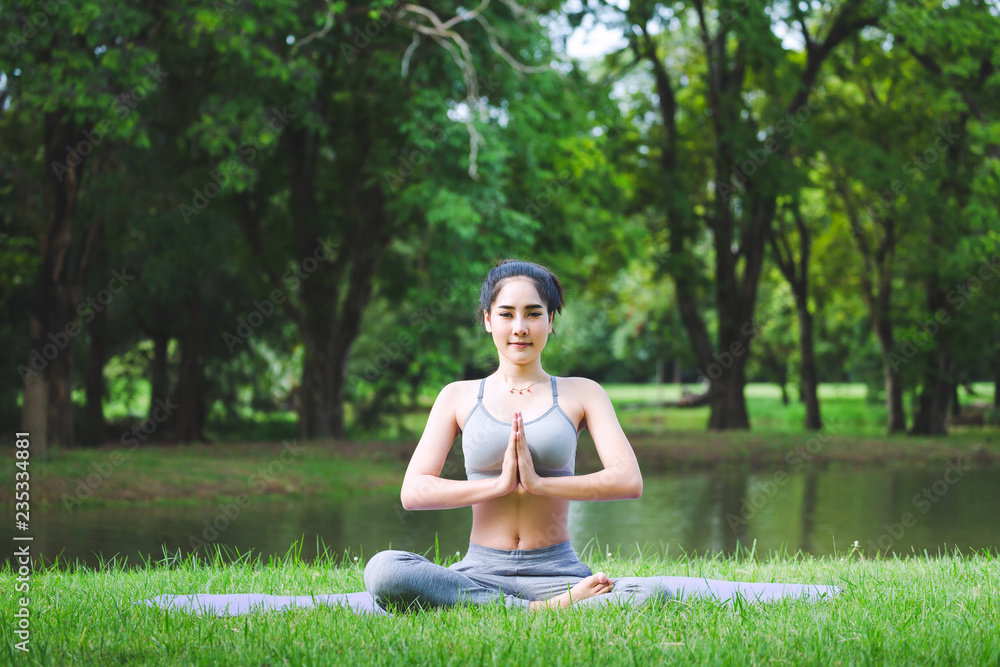 Fitness asian woman doing yoga in park Fitness asian woman doing yoga in park