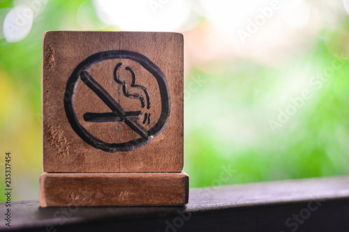 No smoking sign or non smoking area with green nature background. stop smoking and prohibition concept. photo