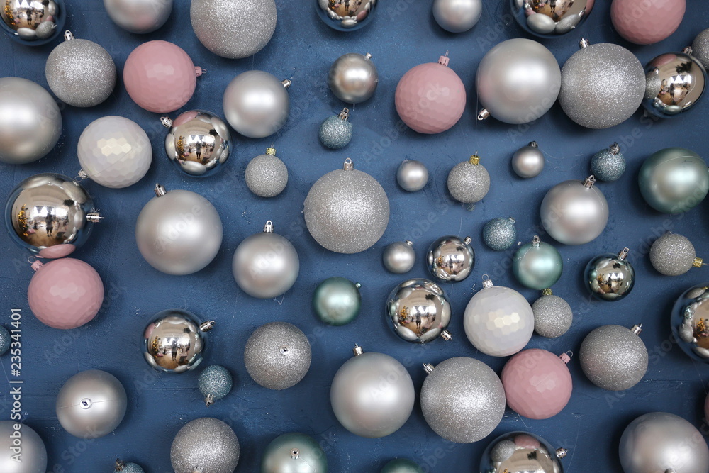 Pink and silver Christmas balls on the background of the dark blue wall. Pink and silver Christmas balls on the background of the dark blue wall.
