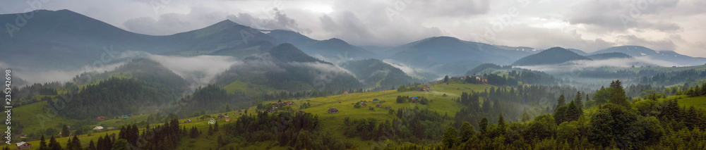 Fantastically beautiful morning in the Carpathians in the summer. amazing view of the mountain village Dzembronya foggy morning in the mountains in summer. - obrazy, fototapety, plakaty 