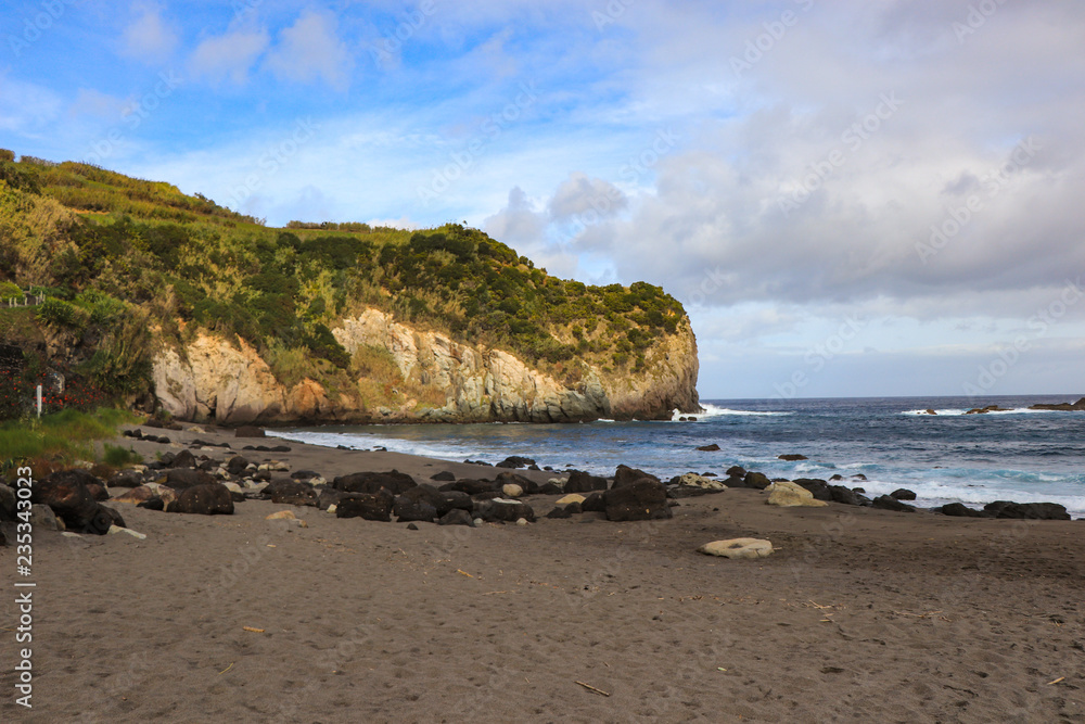 beach with black volcanic sand with turquoise sea water. Seascape in the Portuguese coastline. Azores islands. beach with black volcanic sand with turquoise sea water. Seascape in the Portuguese coastline. Azores islands.