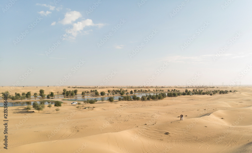 couple in a desert near Al Qudra Lakes near Dubai