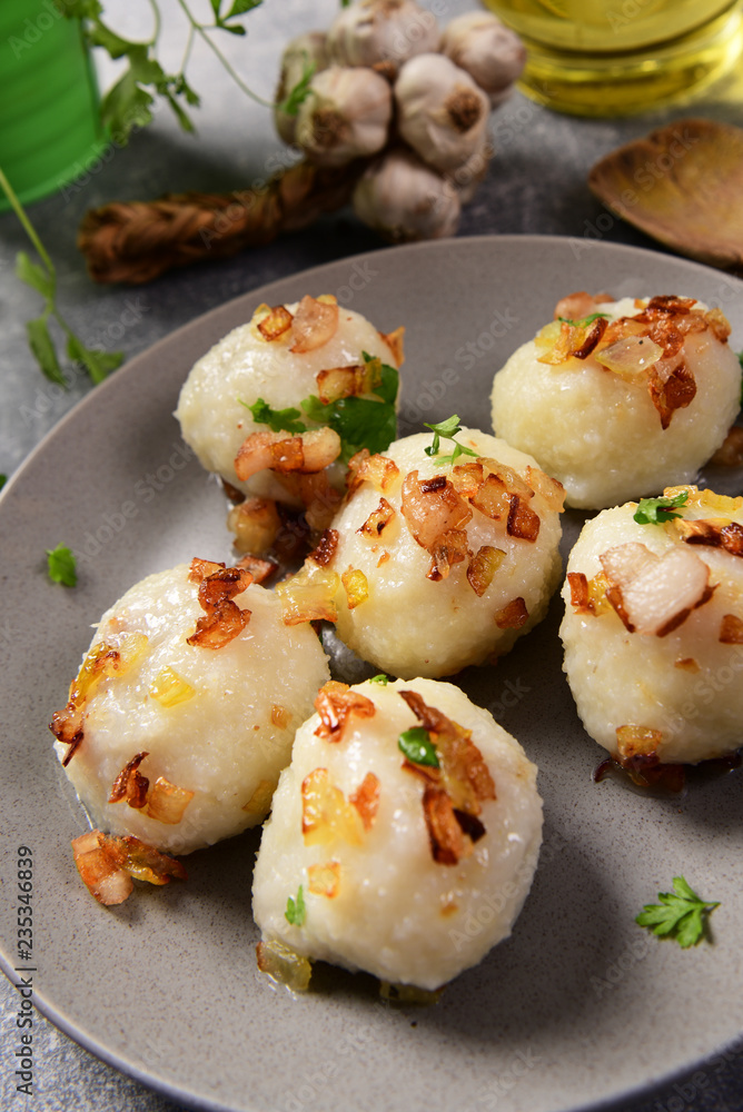 Meat stuffed potato dumplings with fried onion and greaves on top Meat stuffed potato dumplings with fried onion and greaves on top