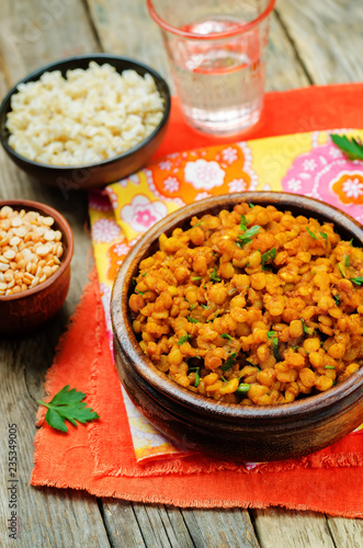 Split peas dal in a bowl on a wood background