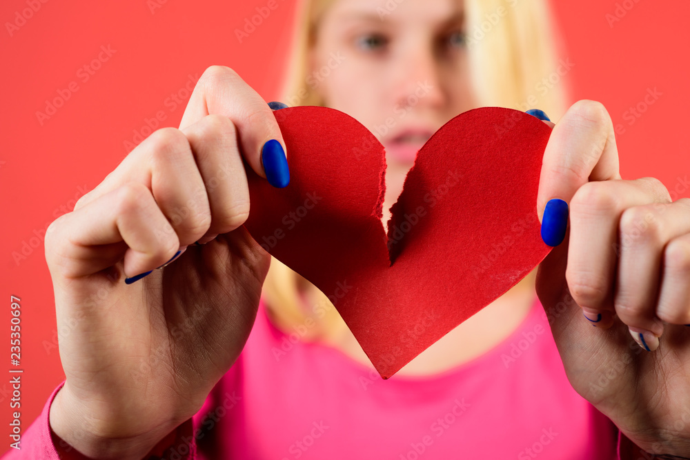 Blond woman tearing heart in half. Girl with broken heart. Female hands ...