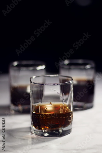 Old fashion glass of whiskey and cola on a dark background