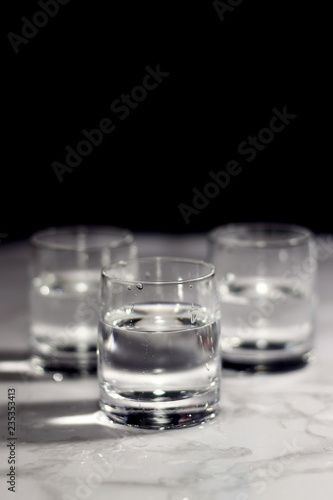 Relaxing crystal glass shot of vodka on a dark background