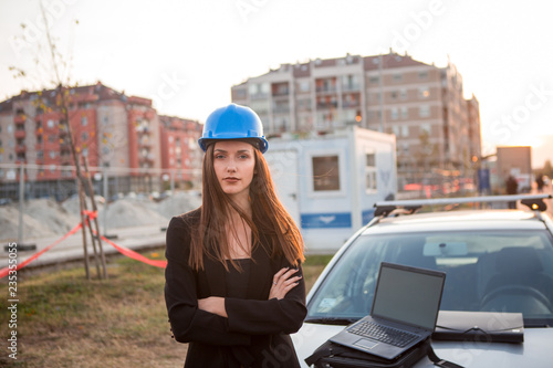 A satisfied female engineer at a construction site.